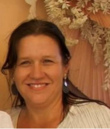 picture of dark haired lady with white top